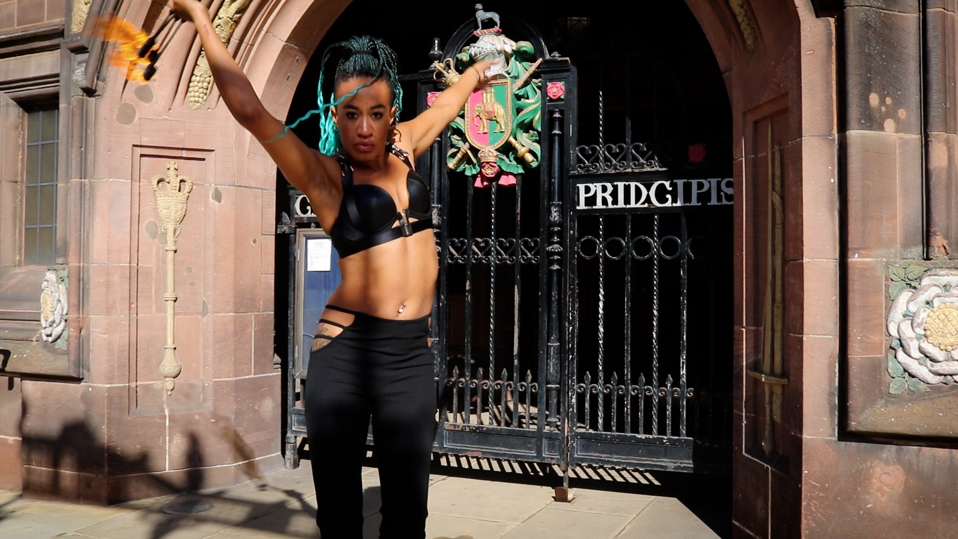 Woman dancing in front of iron gates