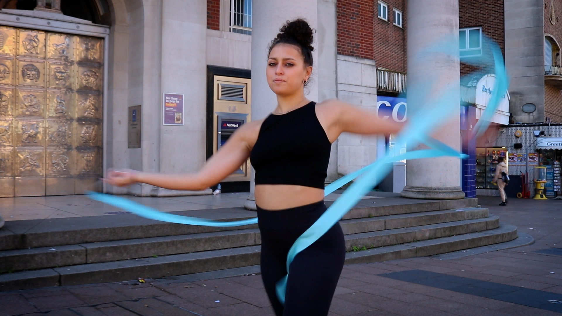 Image of woman dancing with blue ribbon 