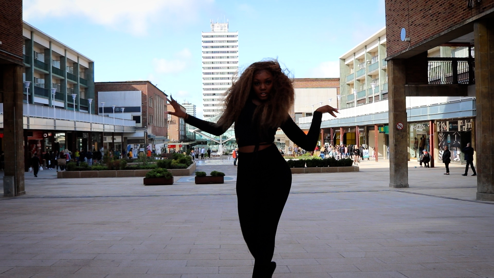 Still from film of Shay Butter dancing silhouetted against Coventry city centre 